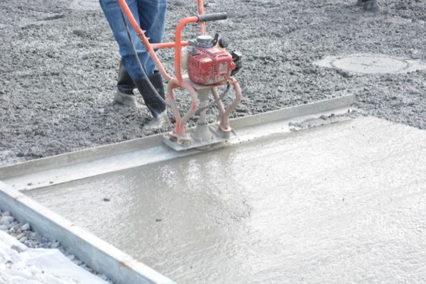 Fresh concrete being poured and finished